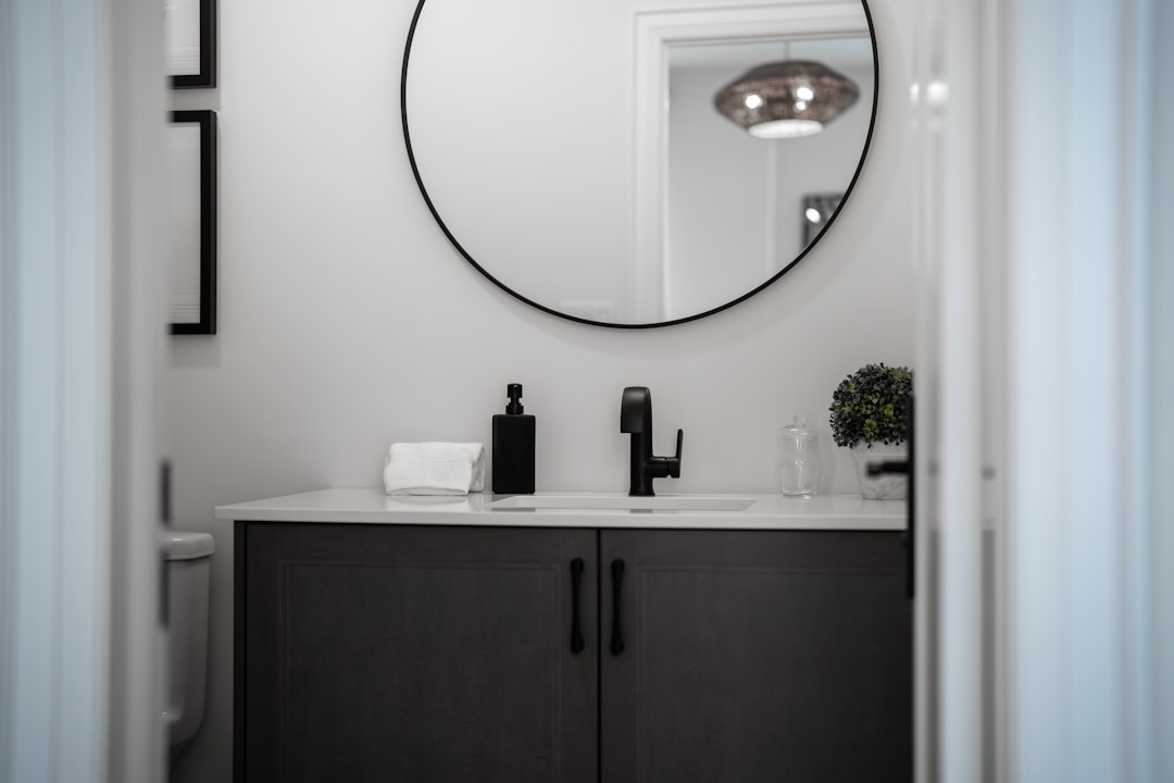 services-04 modern-bathroom-vanity-with-a-round-mirror-above-mgdy-p-o-vo